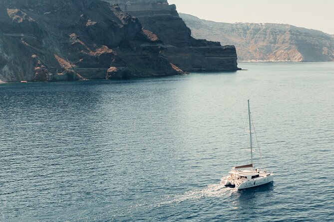 Beautiful Day Catamaran Caldera Cruise incl. Meal & Drinks - Stop 2 Bonus: Volcanic Red Beach Snorkel Time (30 Minutes) That’s Short but Memorable