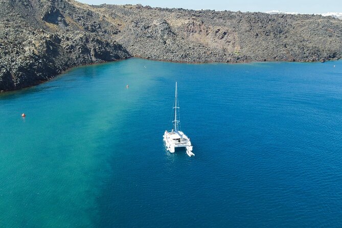 Best of Santorini Private Half-Day Catamaran Cruise with transfer and meal - Your onboard meal: lunch or dinner, cooked while you’re watching the caldera