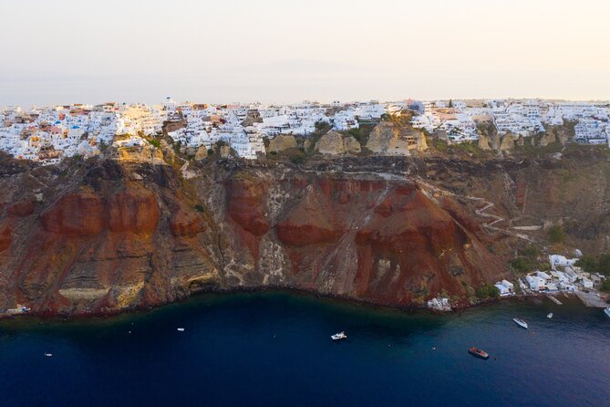 Experience Santorini Sunset by Helicopter - Oia from above: white domes, blue water, and the cliff drop