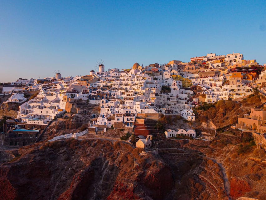 From Fira: Santorini Highlights Minibus Tour with Oia Sunset - Perissa Beach: volcanic black sand, swim time, and lunch options