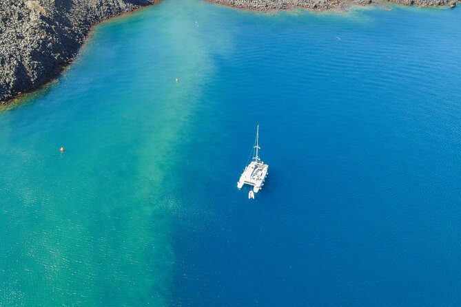Full Day Santorini Catamaran Private Cruise with meal and transfer - Food, drinks, snorkels, and the crew’s real impact