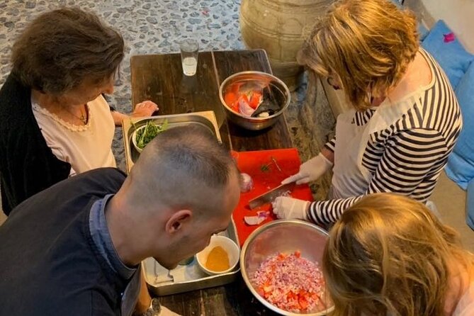 Greek Cuisine Cooking Class in Santorini with Recipes and Wine - Cooking the Classics: Tzatziki, Greek Salad, Tomato Fritters, and Pasticcio