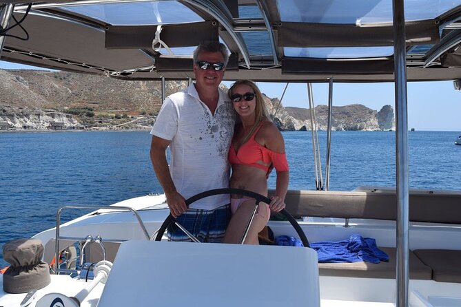 Private Luxury Santorini Catamaran Cruise with Port Pickup - Sailing past White Beach and Indian Rock from the south coast