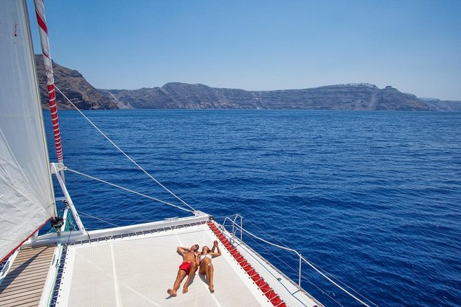 Sailing Catamaran Cruise in Santorini with BBQ, Drinks and Transfer - Ancient Lighthouse Views From Sea: A Quick Scene Change