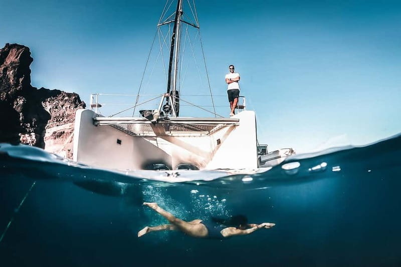 Santorini: All-Inclusive Private Catamaran Experience - Passing Red Beach and White Beach from Sea Level