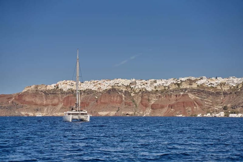 Santorini: Caldera Classic Catamaran Cruise w/ Meal & Drinks - Akrotiri Lighthouse and Indian Face Mountain Pass-by: Fun History Without the Lecture