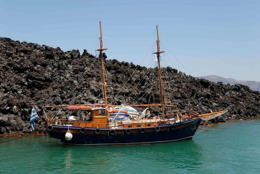 Santorini Caldera: Sunset Cruise with Dinner - Sailing back under Oia: the photo window you don’t want to miss
