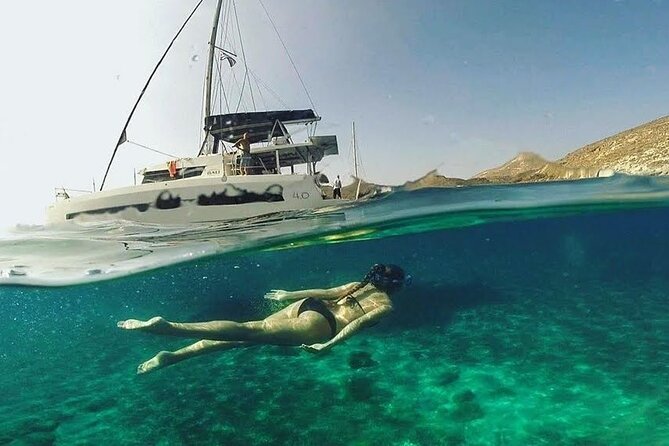 Santorini Catamaran Cruise with Fresh Meal and Open Bar - Red Beach Stop: Rust-Colored Rocks and a Quick Swim