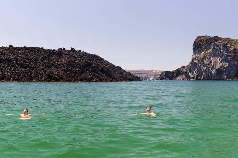 Santorini: Catamaran Cruise with Fresh Meal & Open Bar - Swim and snorkel stops: Black Mountain coves and the value of gear included