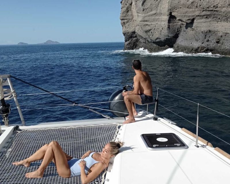 Santorini: Catamaran Cruise with Lunch, Drinks, & Oia Visit - Santorini Caldera Cruising: Indian Rocks and a Lighthouse Pass-By