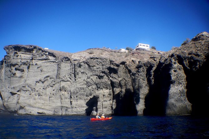 Santorini Guided Sea Kayaking with Light Lunch and Pick-up Option - White Beach and Red Beach: volcanic color with paddle-level views
