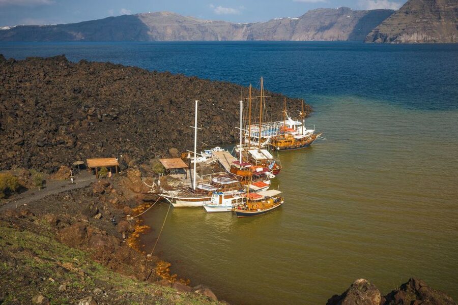 Santorini Island Bus Tour and Caldera Sunset Cruise - Thirasia Island Time: When You Land Ashore vs Stay Aboard