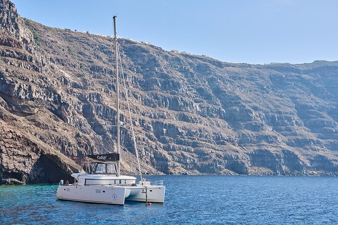 Santorini: Luxury Catamaran Cruise with Fresh Fish BBQ & Drinks - Mesa Pigadia Black Sand, Crystal Water, and the South-Side Feel
