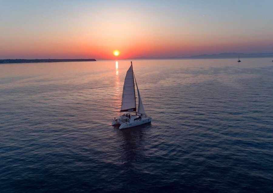 Santorini: Luxury Sunset Cruise with Dinner & Open Bar - The sunset payoff: famous colors, real atmosphere, and possible weather shifts