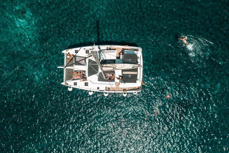 Santorini: Majestic Catamaran Cruise with Meal and Drinks - Getting on the Water: Ammoudi and a Spacious Start