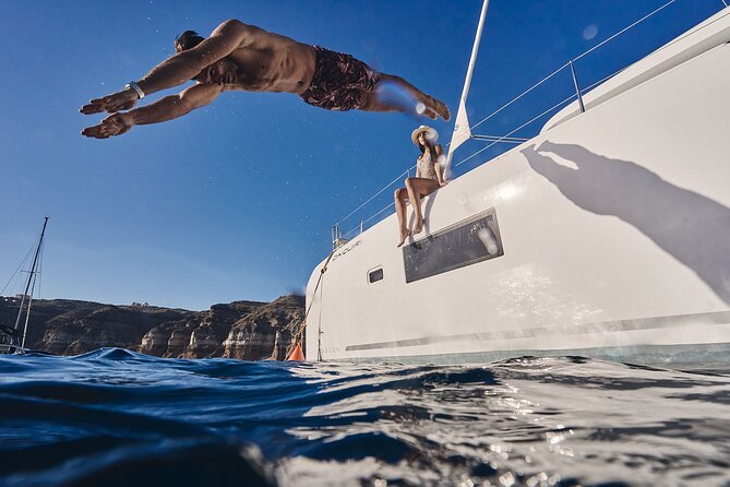 Santorini Oia: Luxury Sunset Cruise with Fresh Fish BBQ & Drinks - Onboard BBQ with fresh fish, unlimited local drinks, and sunset dessert energy