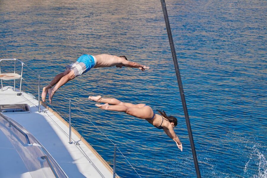 Santorini: Platinum Catamaran Cruise w/ BBQ Meal & Open Bar - Akrotiri Lighthouse sunset sail: wine tasting on the water