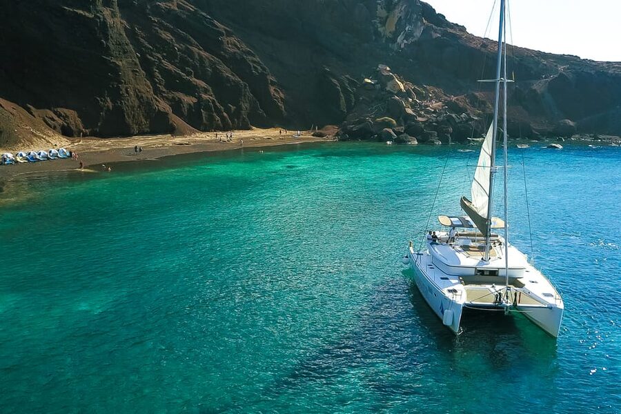 Santorini: Private Catamaran Tour with BBQ Meal and Drinks - Akrotíri pass-by and the sail-by moments: Indian Rocks and the Venetian Lighthouse