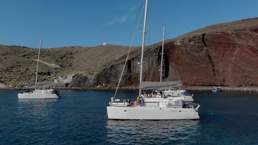 Santorini: Sunset Cruise with Greek Dinner and Transfer - Cruising the caldera cliffs: the views without the hiking