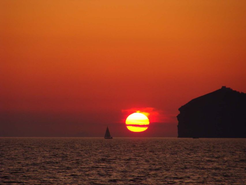 Santorini: Sunset Cruise with Greek Dinner and Transfer - Red Beach and White Beach swim stops that fit into a 5-hour evening