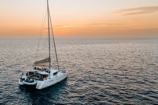Santorini Sunset Sailing Cruise: Dinner, BBQ, Open Bar, Transfers - Sailing highlights: White Beach, Indian Rocks, and the Venetian Lighthouse