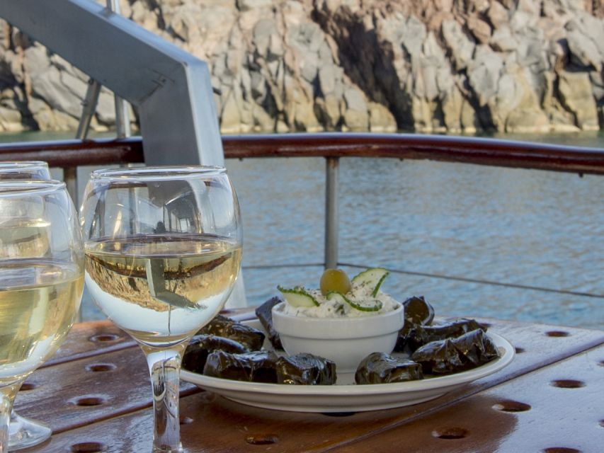 Santorini: Traditional Wooden Boat Tour with Meal and Wine - Red Beach, White Beach, and Akrotiri Lighthouse: the quick-hit photo and swim moments